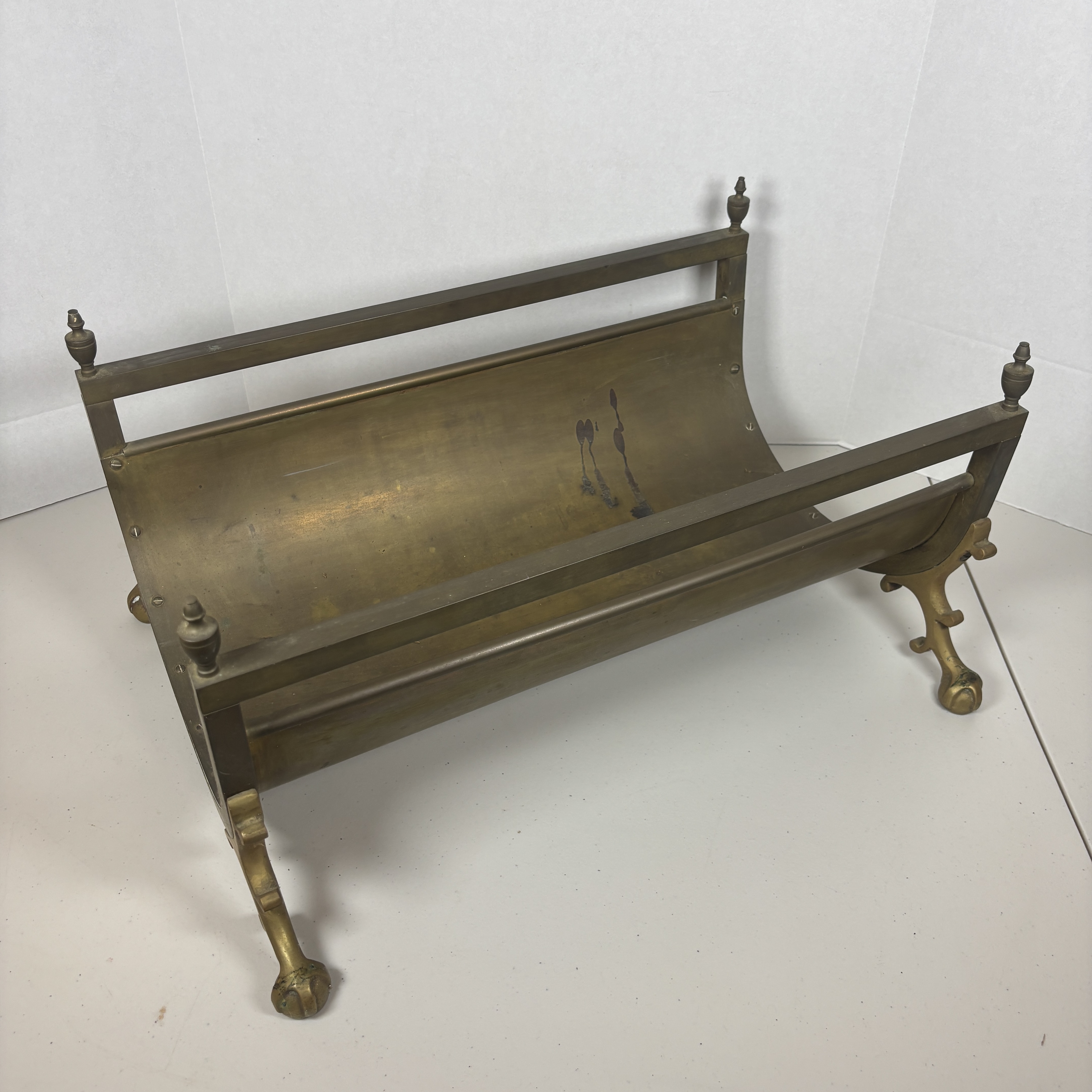 Jansen style brass fireplace log holder with ball and claw feet